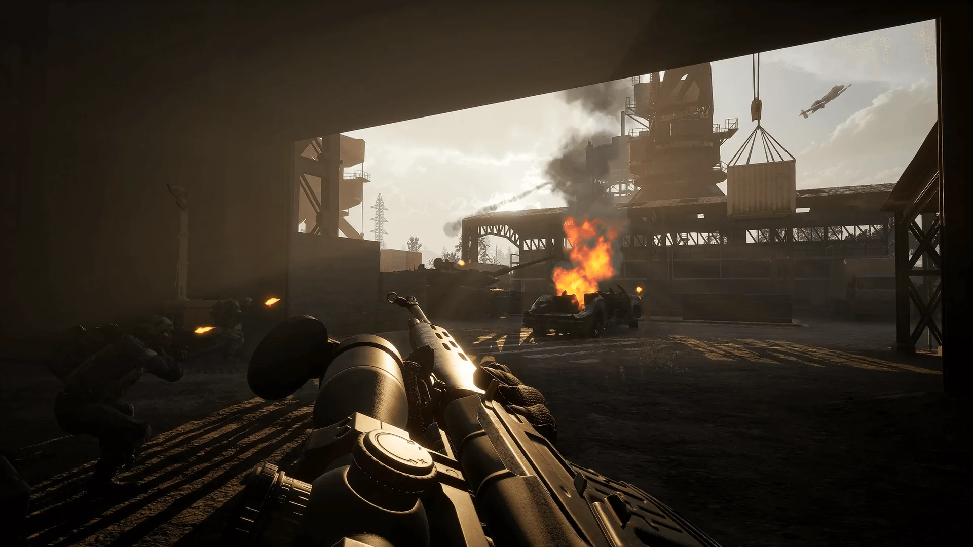 Official WARDOGS concept imagery of a burning industrial yard viewed from inside a building.