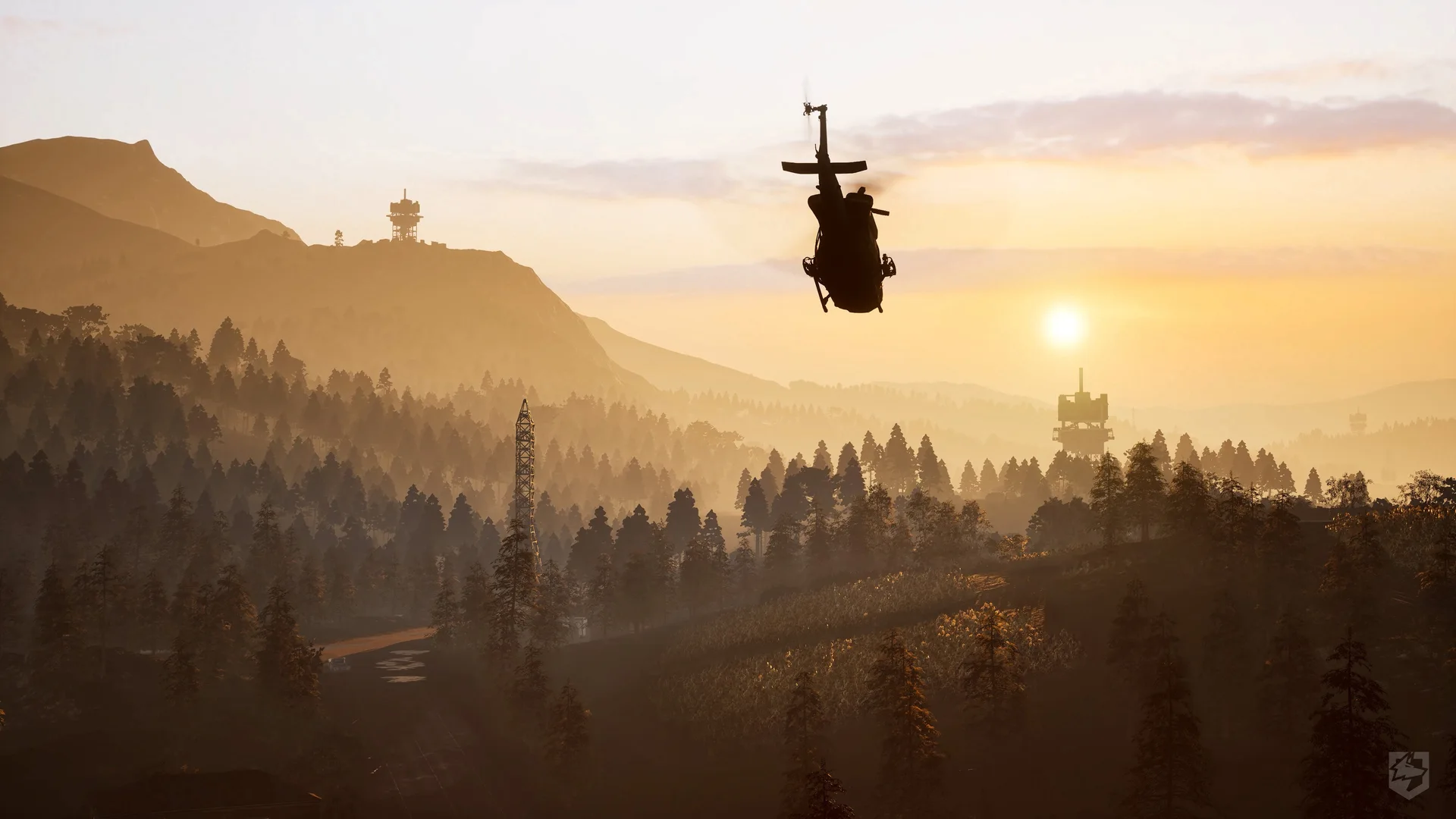 A helicopter flies over a forested mountain valley at sunset in WARDOGS.