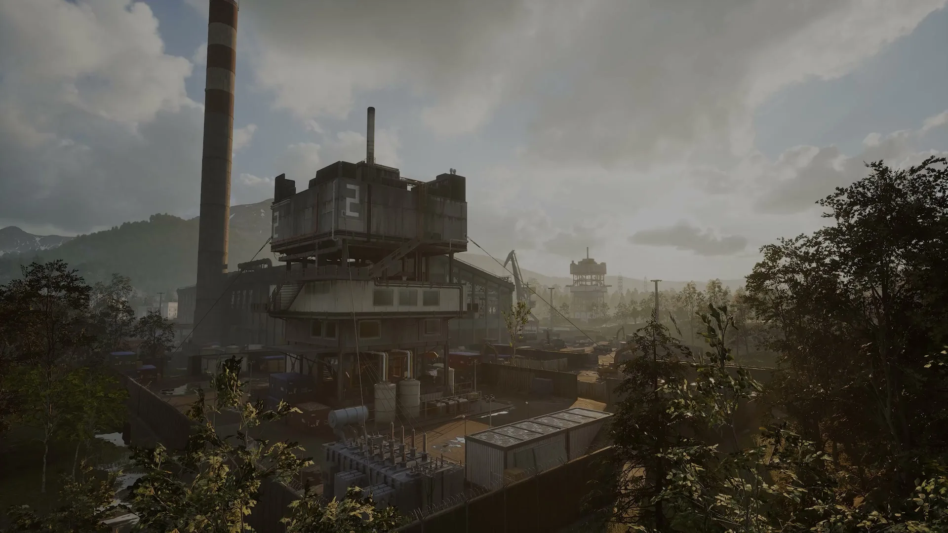 Smokestacks rise over an industrial town in the WARDOGS reveal trailer.